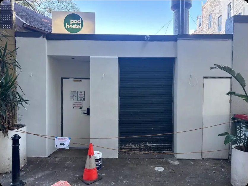 After: commercial roller door shopfront re-rendered and repainted