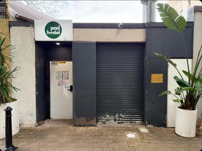 Before: commercial roller door shopfront re-rendered and repainted